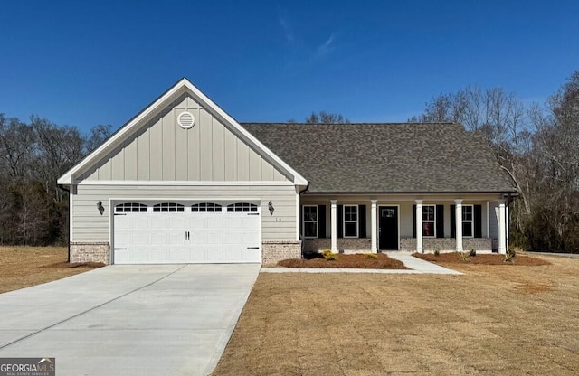 craftsman-style home with brick siding, roof with shingles, an attached garage, board and batten siding, and driveway