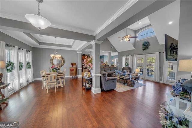 living room featuring decorative columns, a raised ceiling, ornamental molding, wood finished floors, and french doors