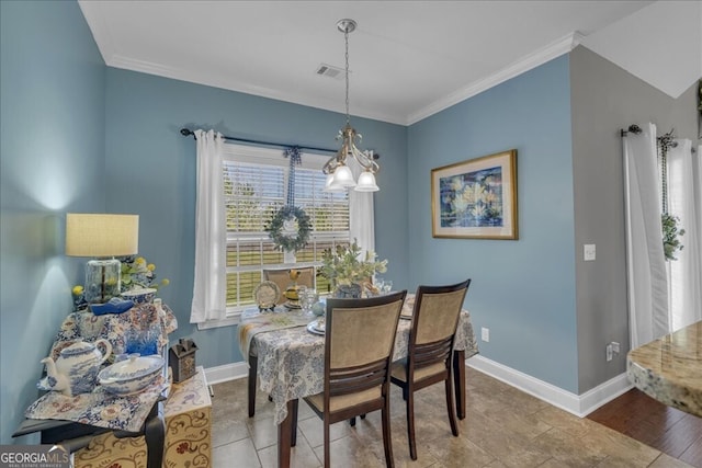 dining area featuring baseboards, visible vents, and ornamental molding