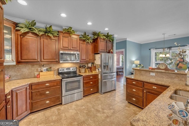 kitchen with light stone counters, hanging light fixtures, appliances with stainless steel finishes, brown cabinets, and glass insert cabinets