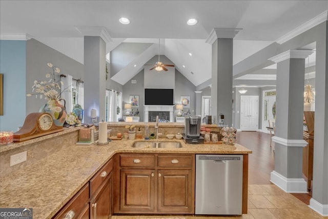 kitchen with dishwasher, open floor plan, a sink, and decorative columns