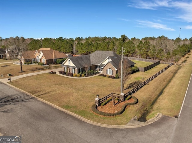 bird's eye view with a wooded view