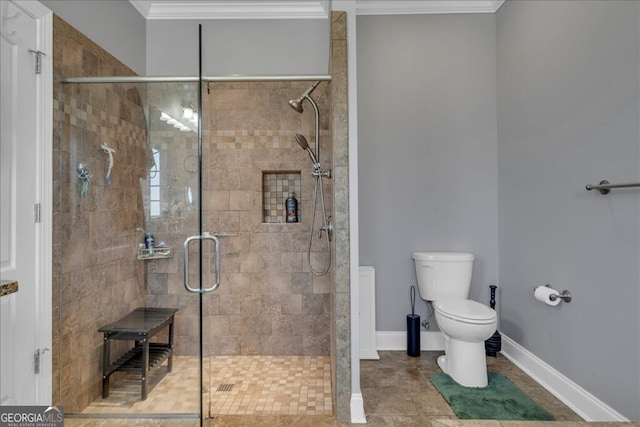 bathroom featuring baseboards, a stall shower, toilet, and crown molding