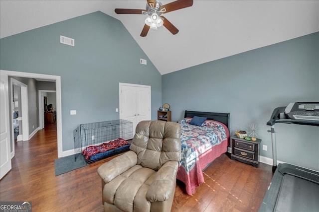 bedroom with baseboards, visible vents, dark wood-style floors, ceiling fan, and high vaulted ceiling