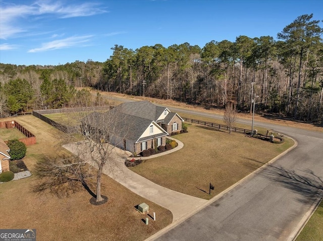 drone / aerial view featuring a wooded view