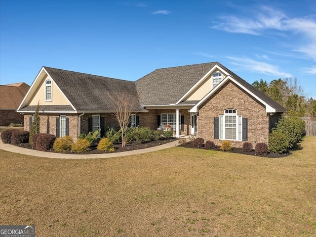 view of front of property featuring a front yard and brick siding