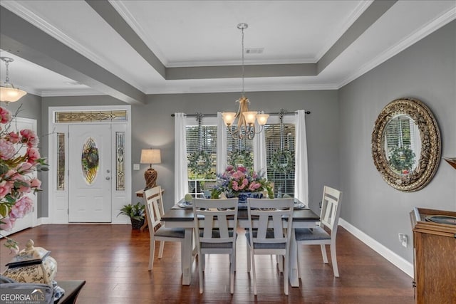 dining room with dark wood-style floors, a raised ceiling, visible vents, and an inviting chandelier