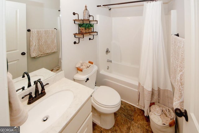 bathroom featuring toilet, shower / tub combo, stone finish floor, and vanity