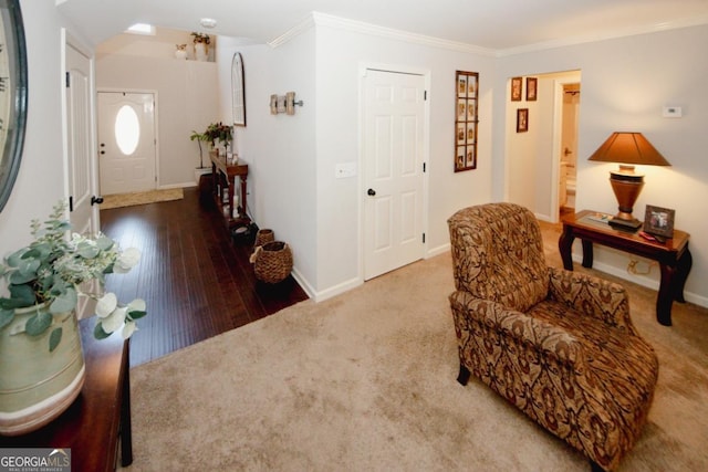 living area with baseboards, carpet floors, and crown molding