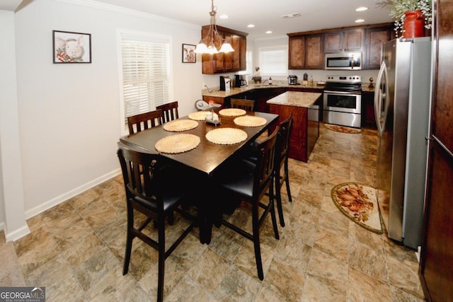 dining room featuring baseboards, recessed lighting, and crown molding