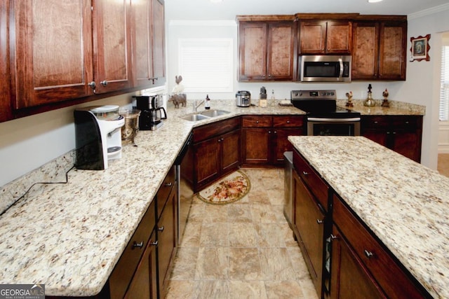 kitchen with light stone countertops, ornamental molding, stainless steel appliances, and a sink