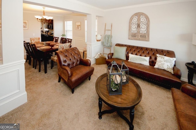 living area with a notable chandelier, a wainscoted wall, a decorative wall, carpet flooring, and ornamental molding