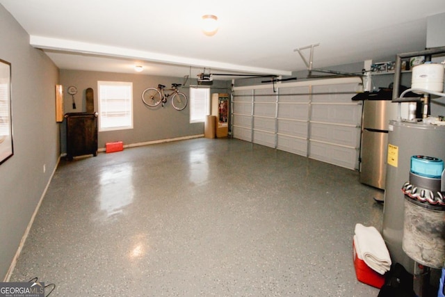 garage with a garage door opener, water heater, and baseboards