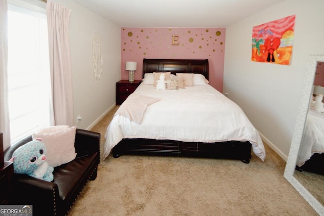 bedroom with multiple windows, baseboards, and light colored carpet