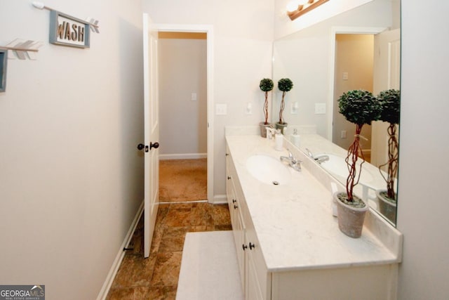 bathroom featuring vanity and baseboards