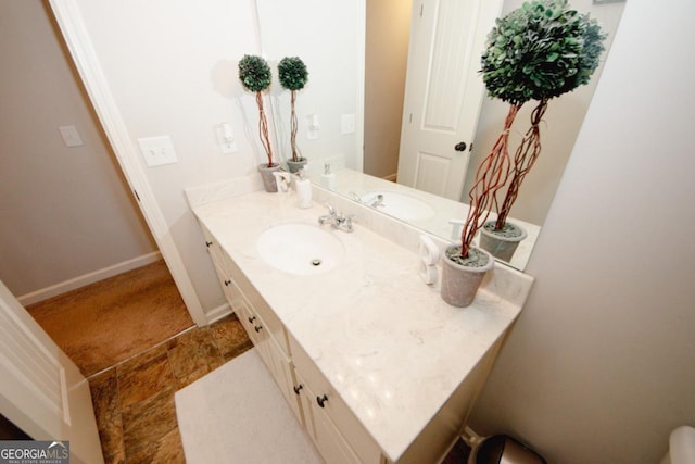 bathroom with vanity and baseboards