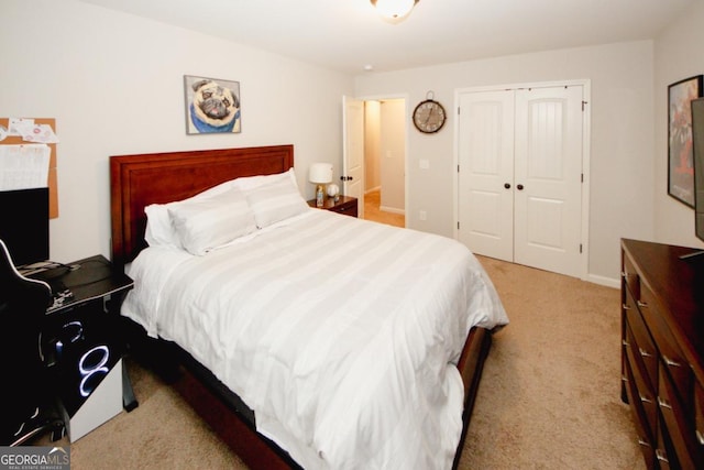 bedroom with a closet and light colored carpet