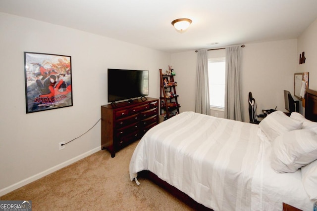 bedroom featuring light colored carpet and baseboards