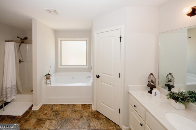 full bathroom with a bath, a stall shower, vanity, and visible vents