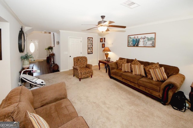 carpeted living room featuring ceiling fan, baseboards, visible vents, and crown molding