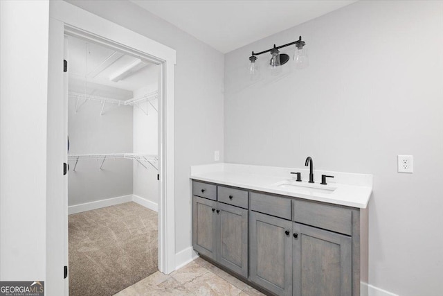 bathroom with vanity and baseboards