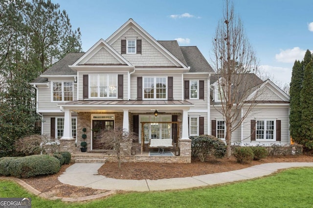 craftsman-style house featuring covered porch and brick siding