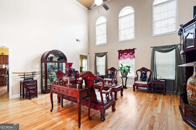 living room with visible vents, plenty of natural light, and wood finished floors