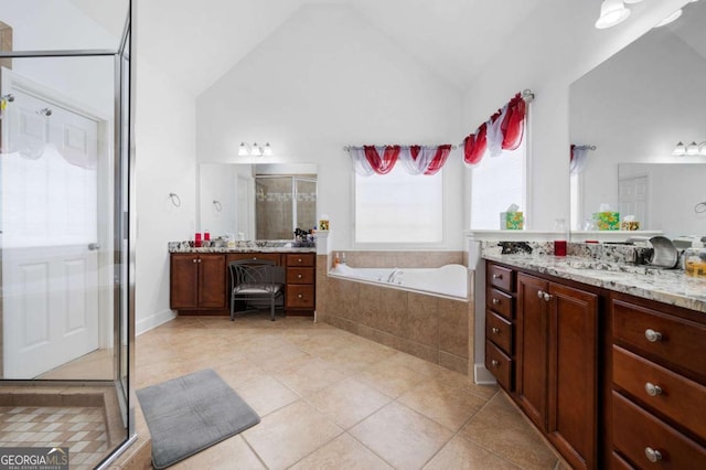 full bathroom with a stall shower, lofted ceiling, a garden tub, tile patterned flooring, and two vanities