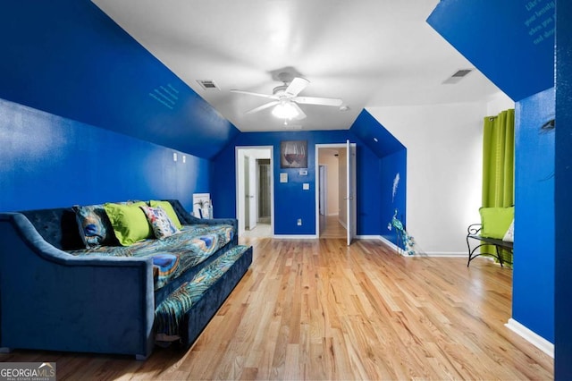 interior space featuring ceiling fan, visible vents, and wood finished floors