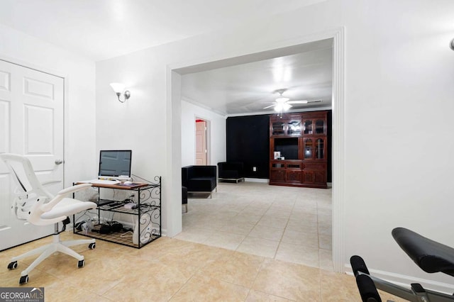 home office with a ceiling fan, light tile patterned flooring, and baseboards