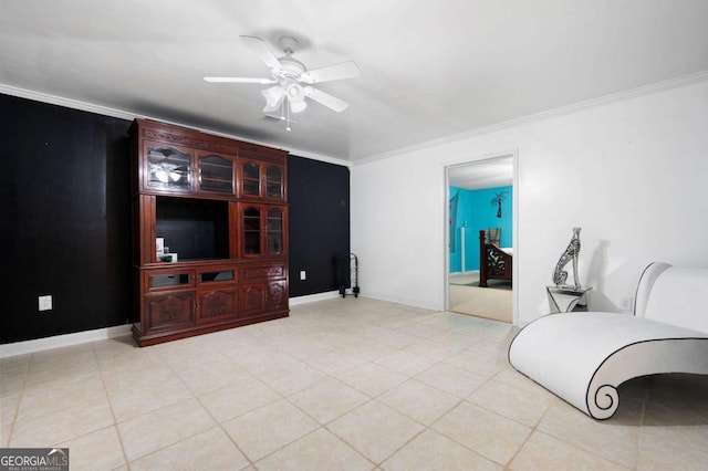 living area with ornamental molding, a ceiling fan, and baseboards