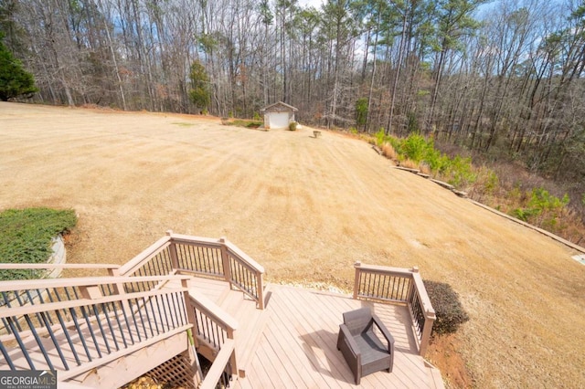 exterior space featuring an outdoor structure, a deck, and a shed