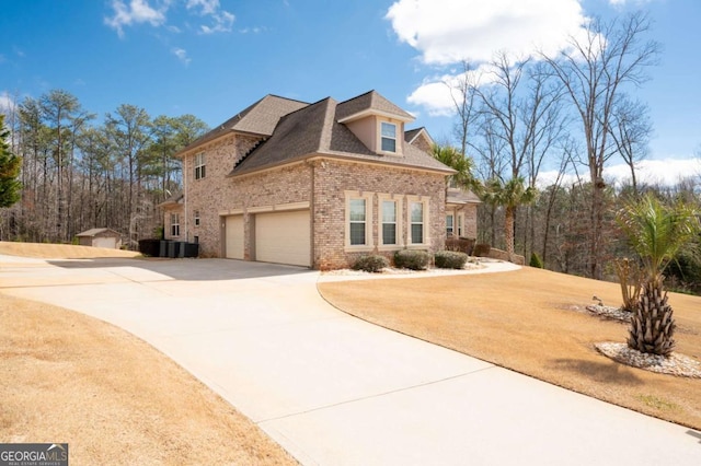 view of front of house with roof with shingles, concrete driveway, and brick siding