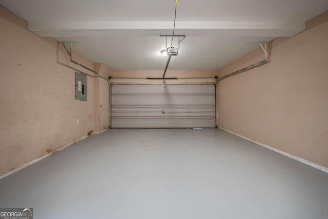 garage featuring electric panel and a garage door opener