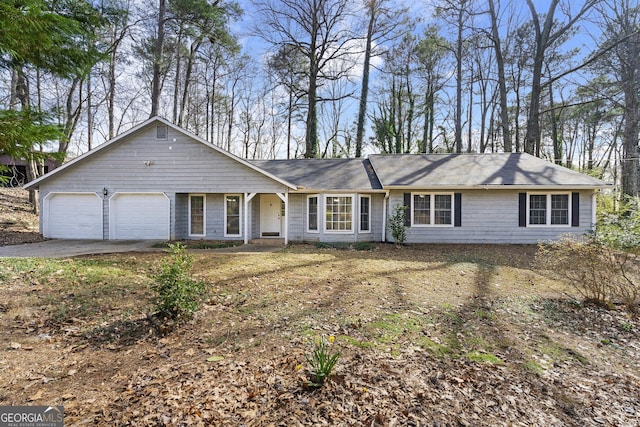 single story home with driveway and an attached garage