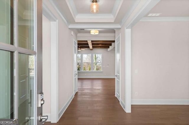 hallway featuring dark wood-style floors, ornamental molding, and baseboards