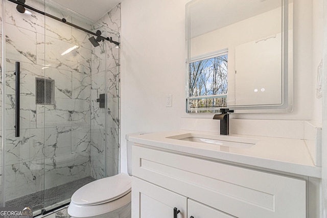 full bathroom with a marble finish shower, vanity, and toilet