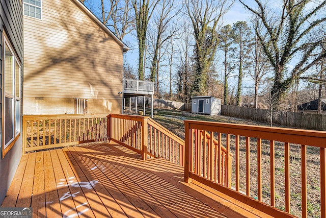 deck featuring an outbuilding, a shed, and a fenced backyard