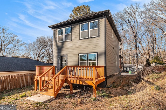 back of house with stairs, fence, and a deck