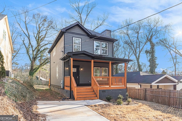 view of front facade with a porch, crawl space, and fence