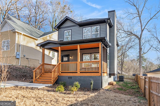 view of front of home with covered porch, central AC, fence, crawl space, and a chimney