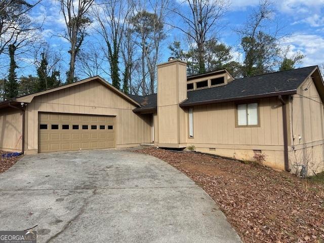 view of front of house with a garage, a shingled roof, driveway, crawl space, and a chimney