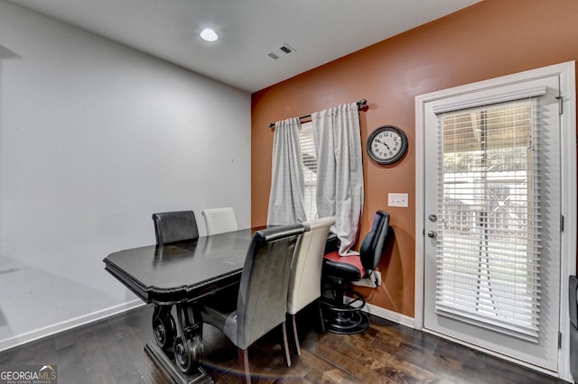 dining space with baseboards, visible vents, and dark wood-type flooring