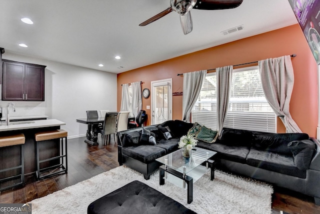 living room featuring ceiling fan, dark wood finished floors, visible vents, and recessed lighting