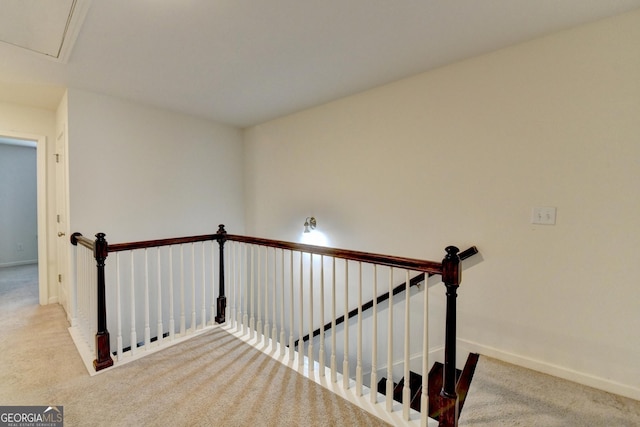 staircase featuring carpet flooring and baseboards