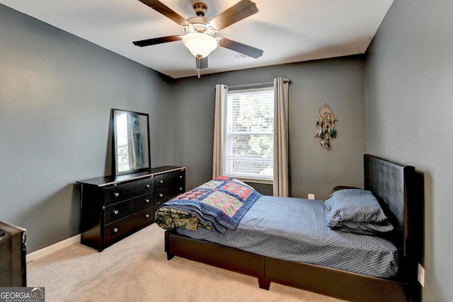 bedroom with ceiling fan, baseboards, and light colored carpet