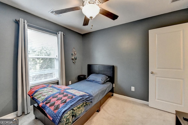 bedroom featuring a ceiling fan, light carpet, visible vents, and baseboards