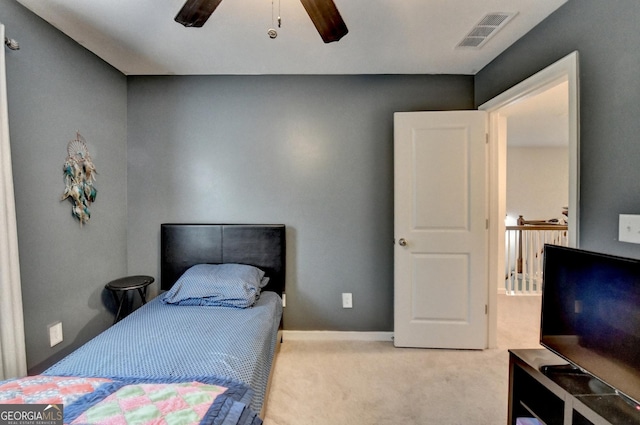 bedroom featuring light carpet, baseboards, visible vents, and a ceiling fan