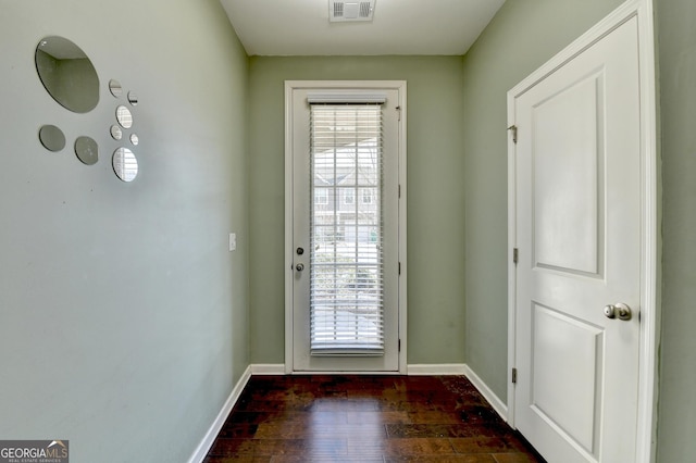 doorway featuring dark wood-type flooring, visible vents, plenty of natural light, and baseboards