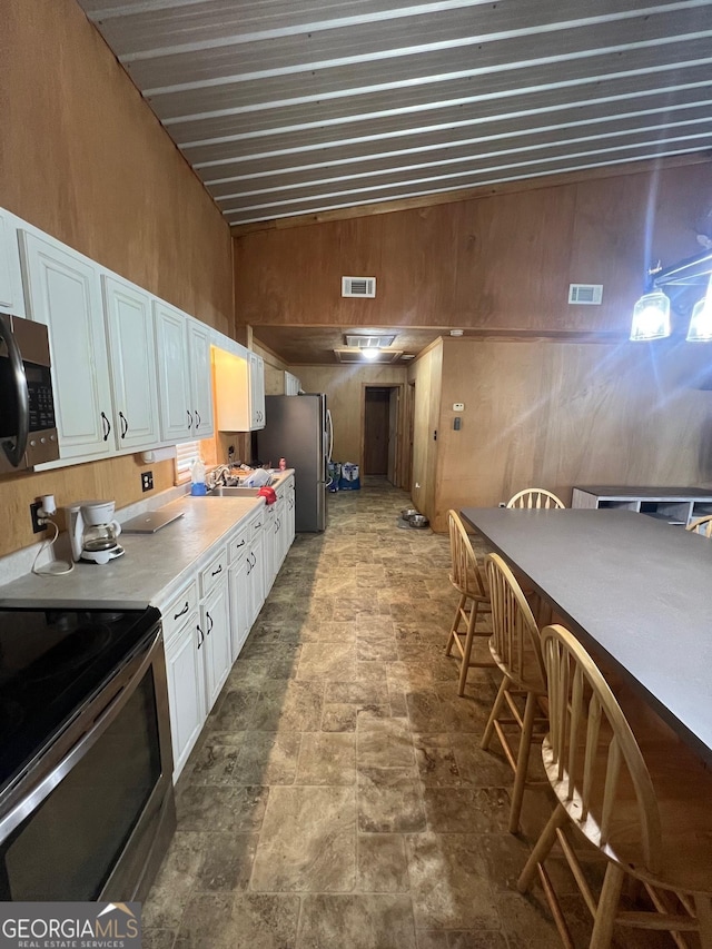 kitchen with visible vents, appliances with stainless steel finishes, white cabinetry, and light countertops